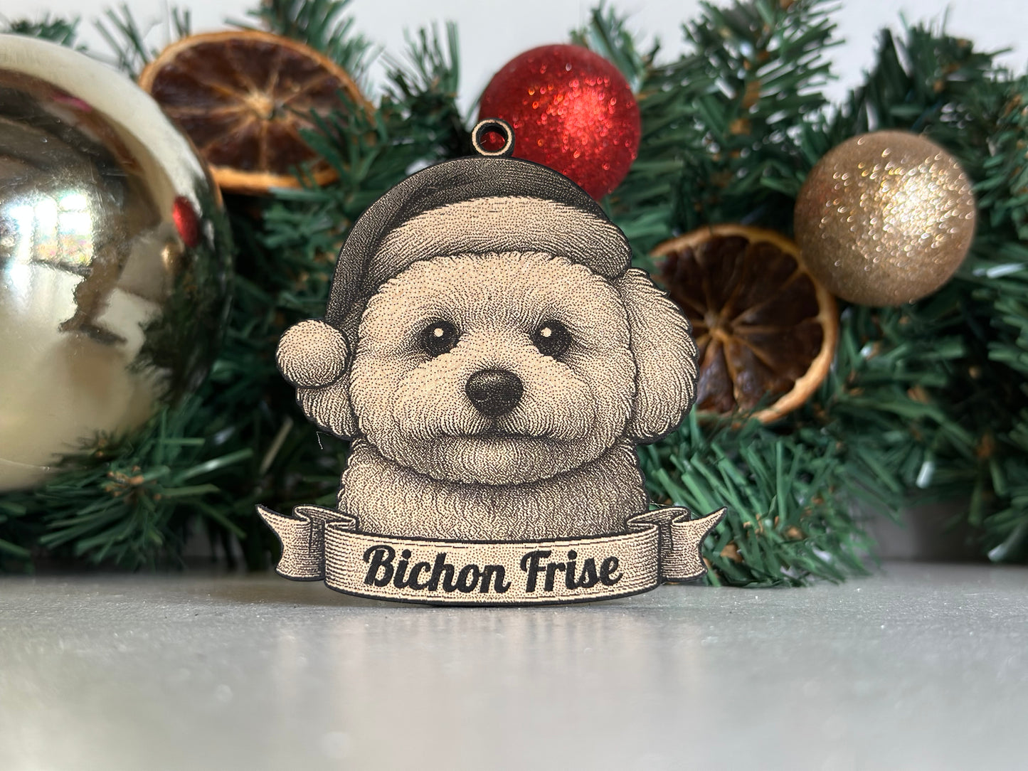 Decorative ornament of a dog wearing a 'Bichon Frise' hat on a Christmas tree.