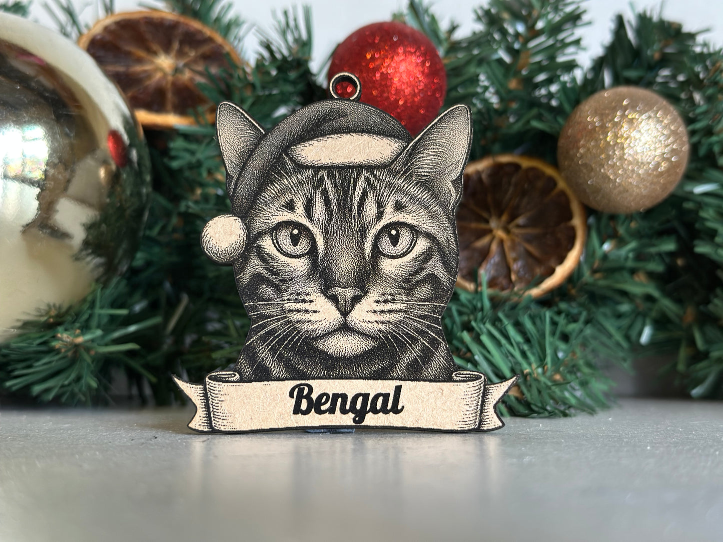 Decorative Christmas stocking with a cat design and 'Bengal' text, surrounded by Christmas decorations.