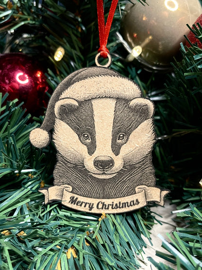 A badger tree ornament with a Santa hat and a banner that reads 'Merry Christmas', 