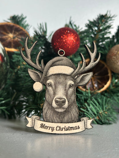 Decorative Stag ornament with 'Merry Christmas' banner on a Christmas tree.
