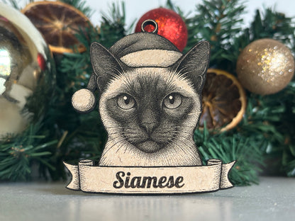Decorative siamese cat ornament with a banner on a Christmas tree.