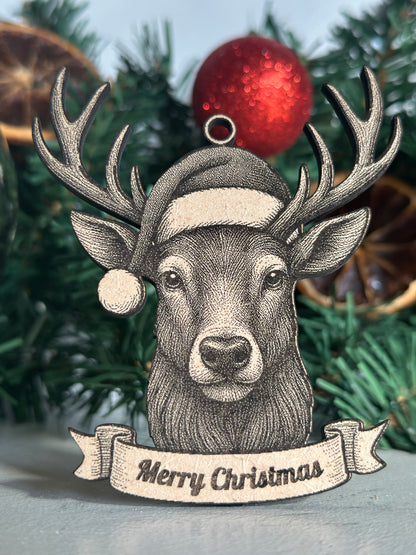 Decorative Stag ornament with 'Merry Christmas' banner on a Christmas tree.