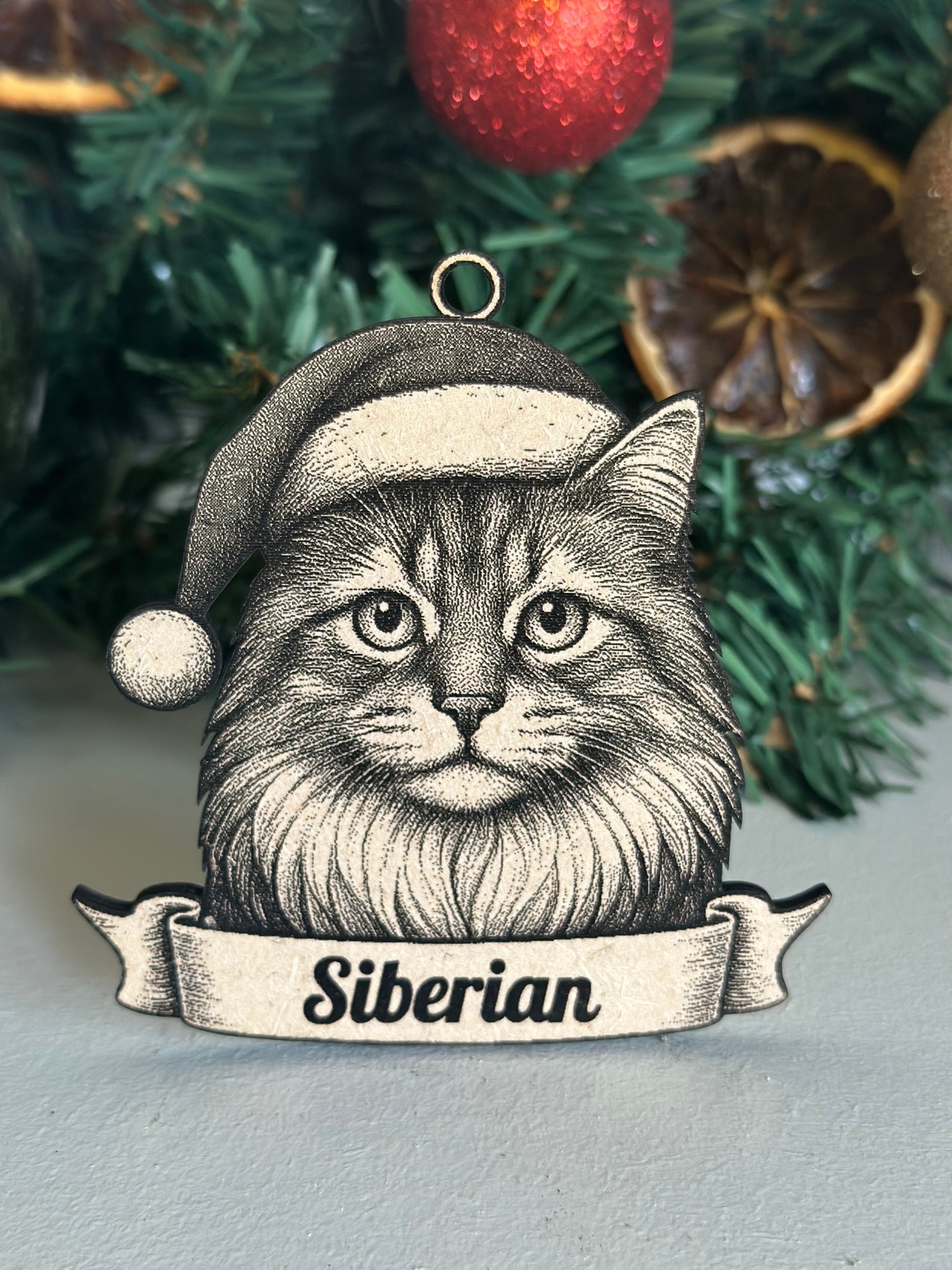 Decorative ornament with a Siberian cat illustration on a Christmas tree background