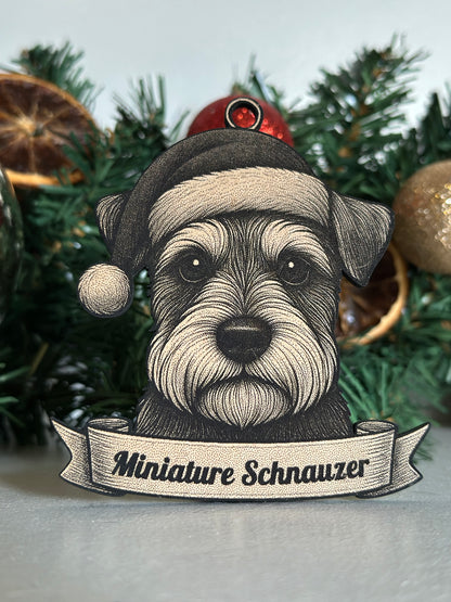 Decorative ornament of a miniature schnauzer dog with a banner on a Christmas tree.