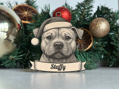 Decorative ornament of a dog with 'Staffy' text on a Christmas tree.
