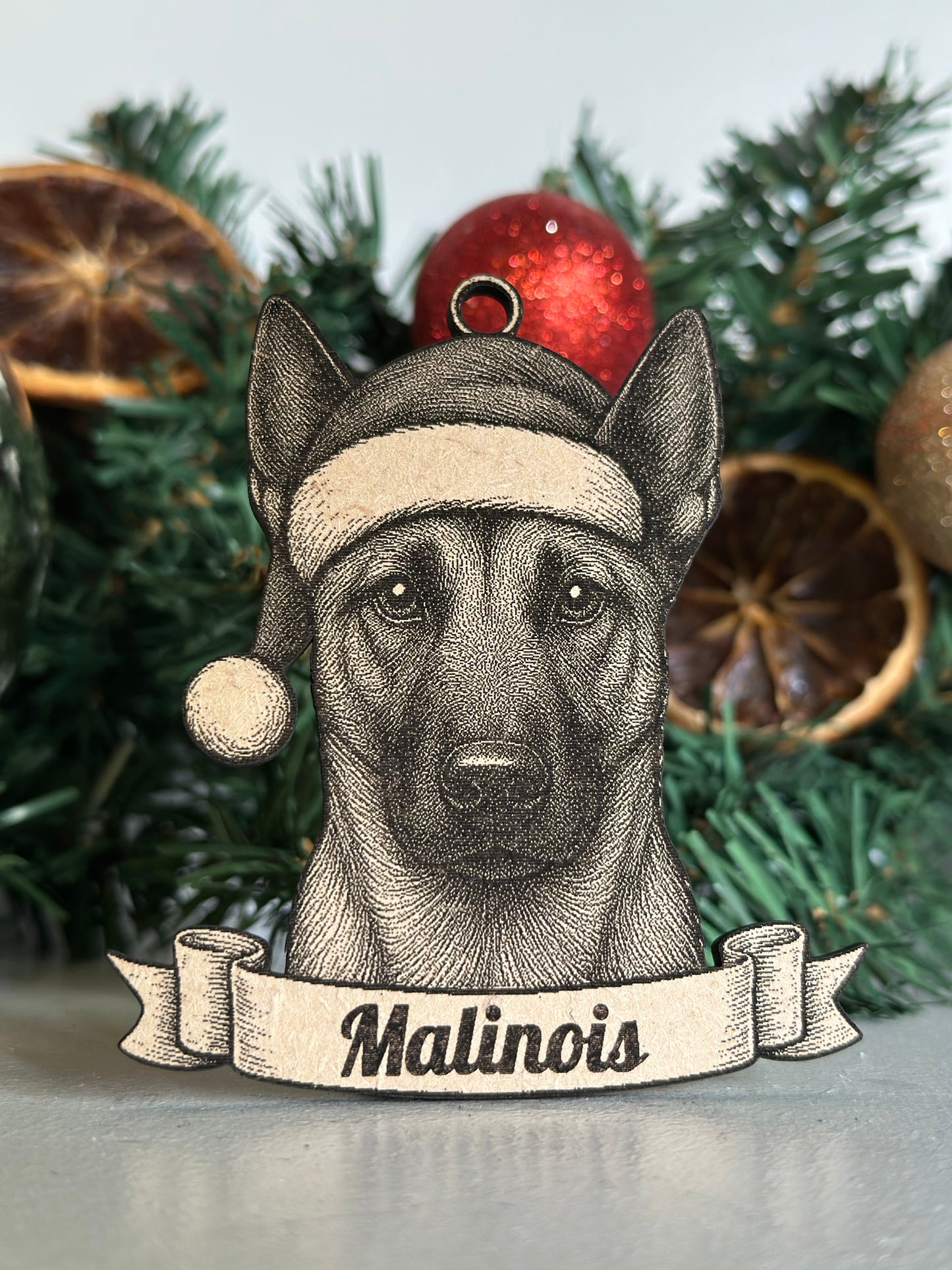 Dog ornament with 'Malinois' label on a Christmas tree