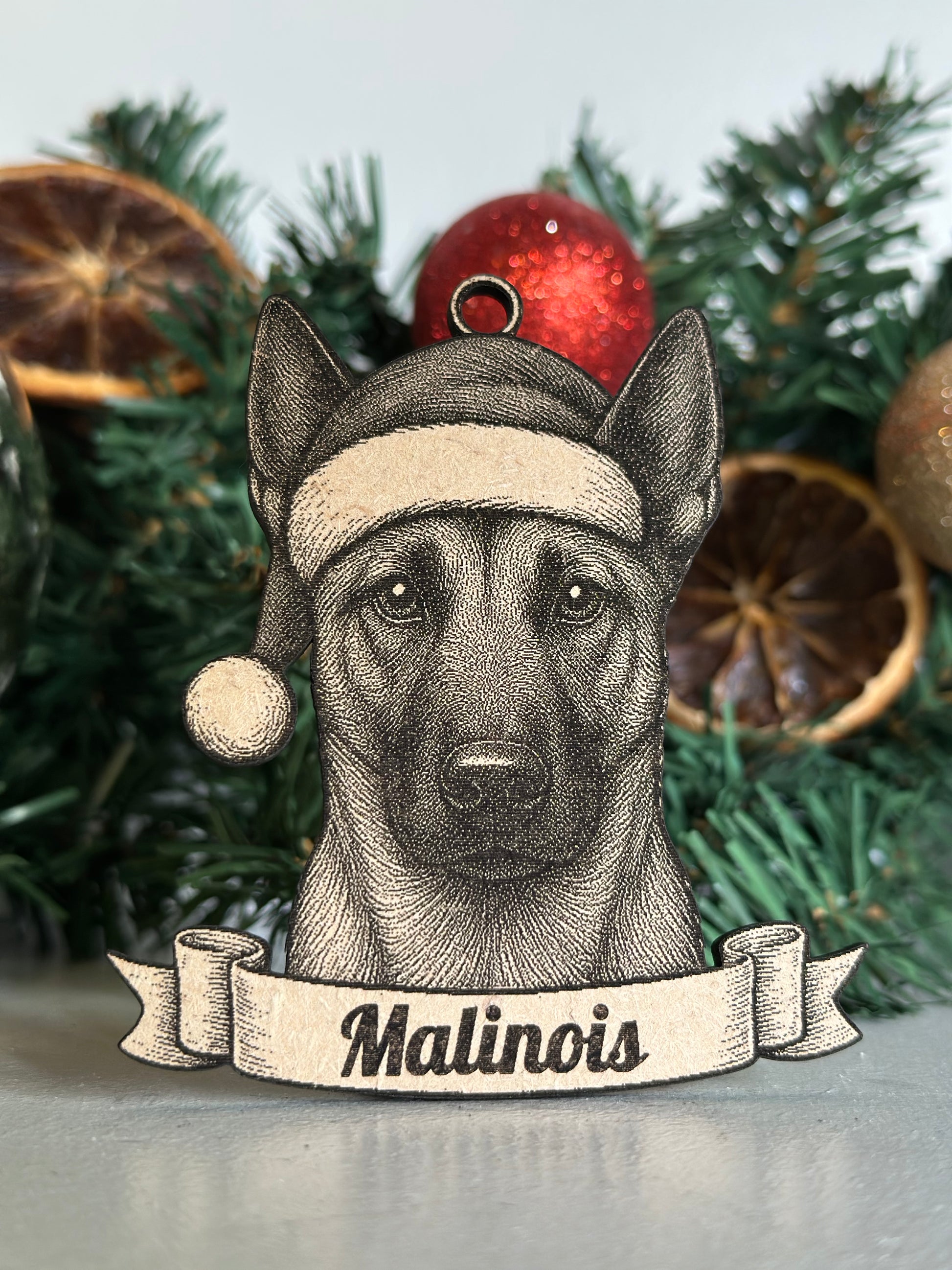 Dog ornament with 'Malinois' label on a Christmas tree