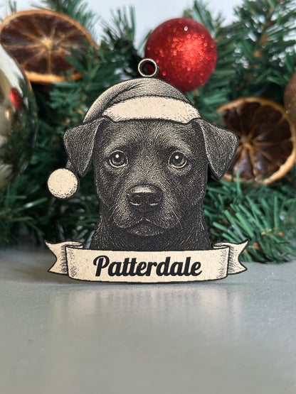 Decorative Christmas ornament with a black dog illustration and 'Patterdale' text on a green tree.