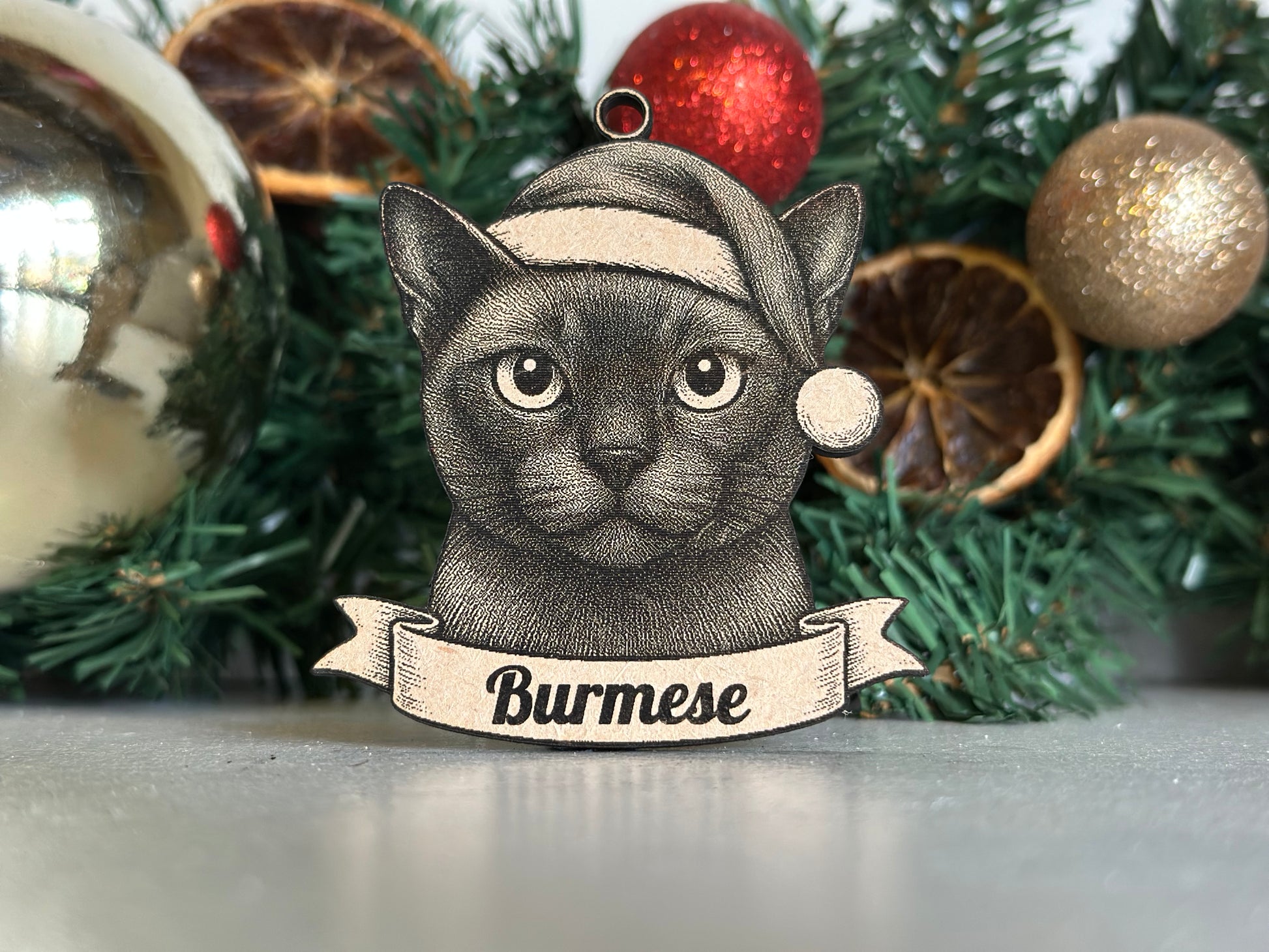 Decorative burmese ornament with a banner on a Christmas tree.