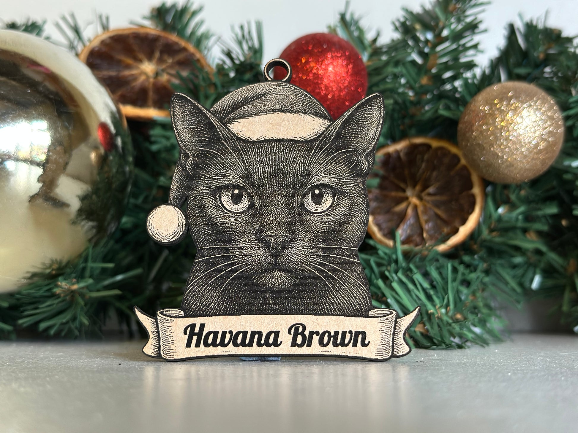 Decorative Christmas ornament with a cat design and 'Havana Brown' banner on a wreath.