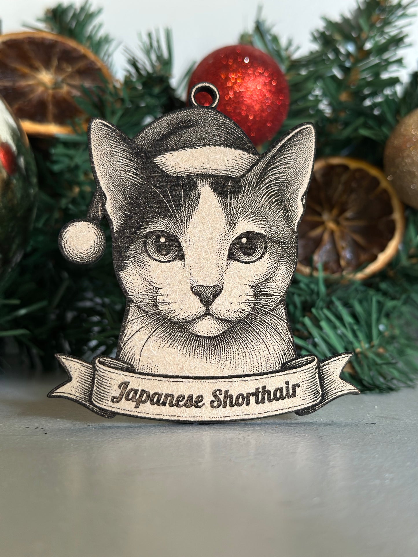 Decorative Christmas ornament with a cat illustration and 'Japanese Shorthair' text on a wreath.