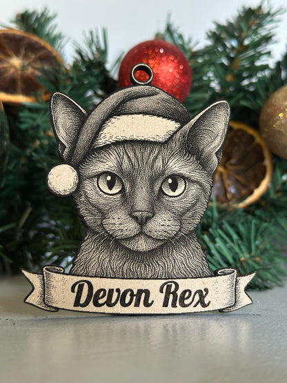 Decorative Devon Rex cat ornament on a Christmas tree with ornaments.