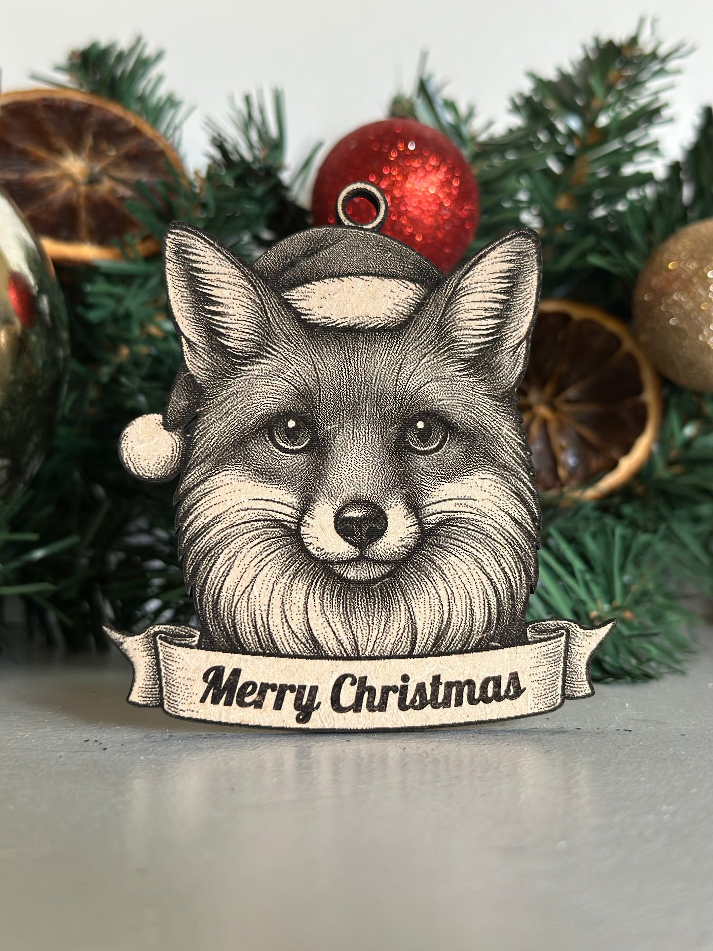 Illustration of a fox wearing a Santa hat with 'Merry Christmas' text, surrounded by festive decorations.