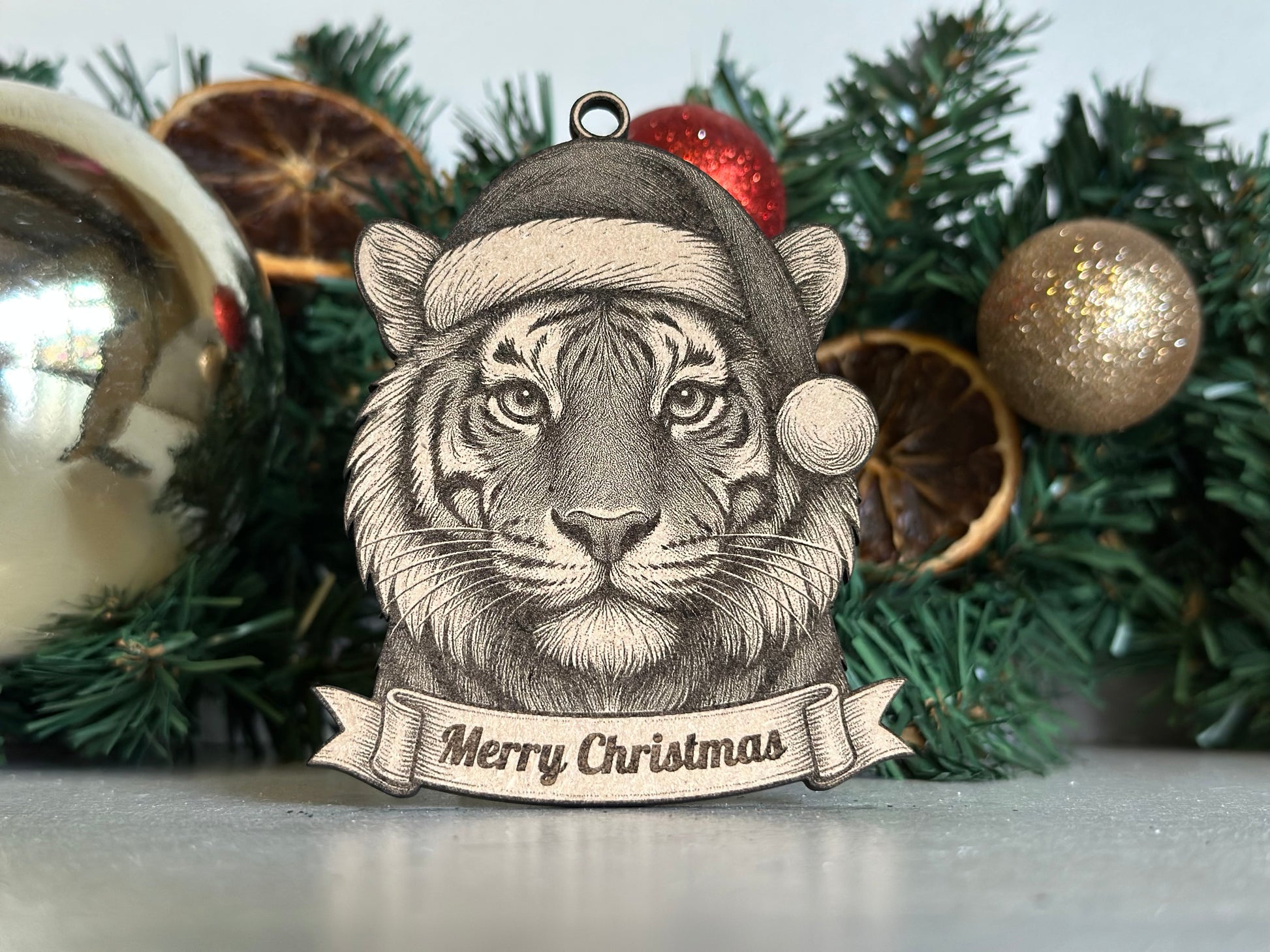 Tiger Christmas ornament with 'Merry Christmas' banner against a festive background