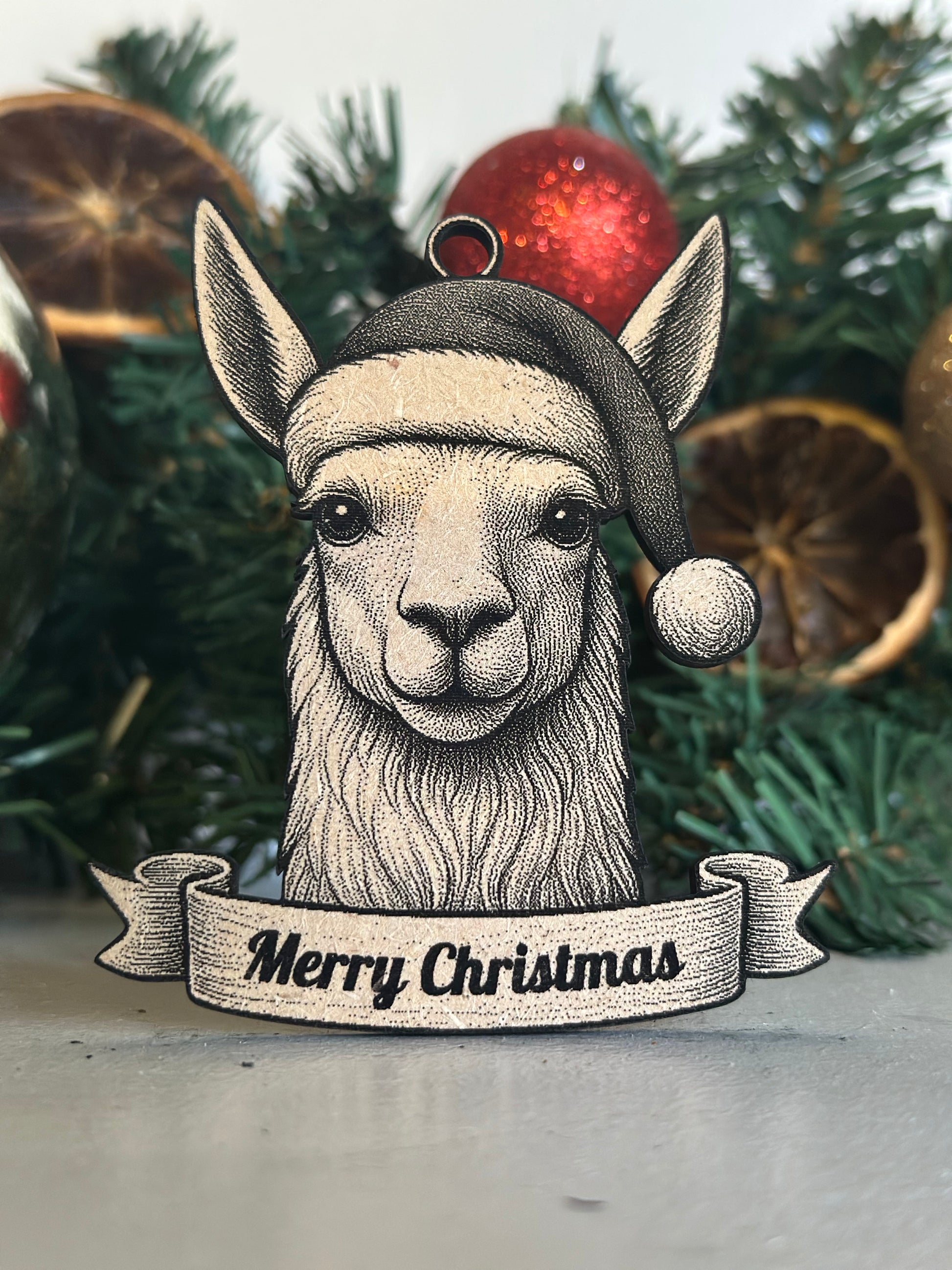 Illustration of a llama wearing a Christmas hat with a 'Merry Christmas' banner against a festive background.
