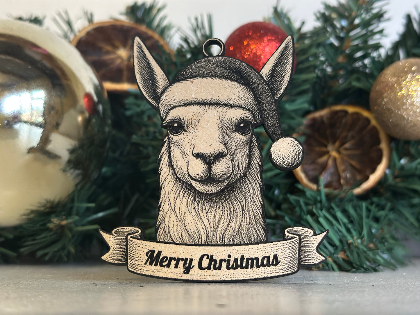 Decorative Christmas ornament with a llama design and 'Merry Christmas' text, set against a festive background.