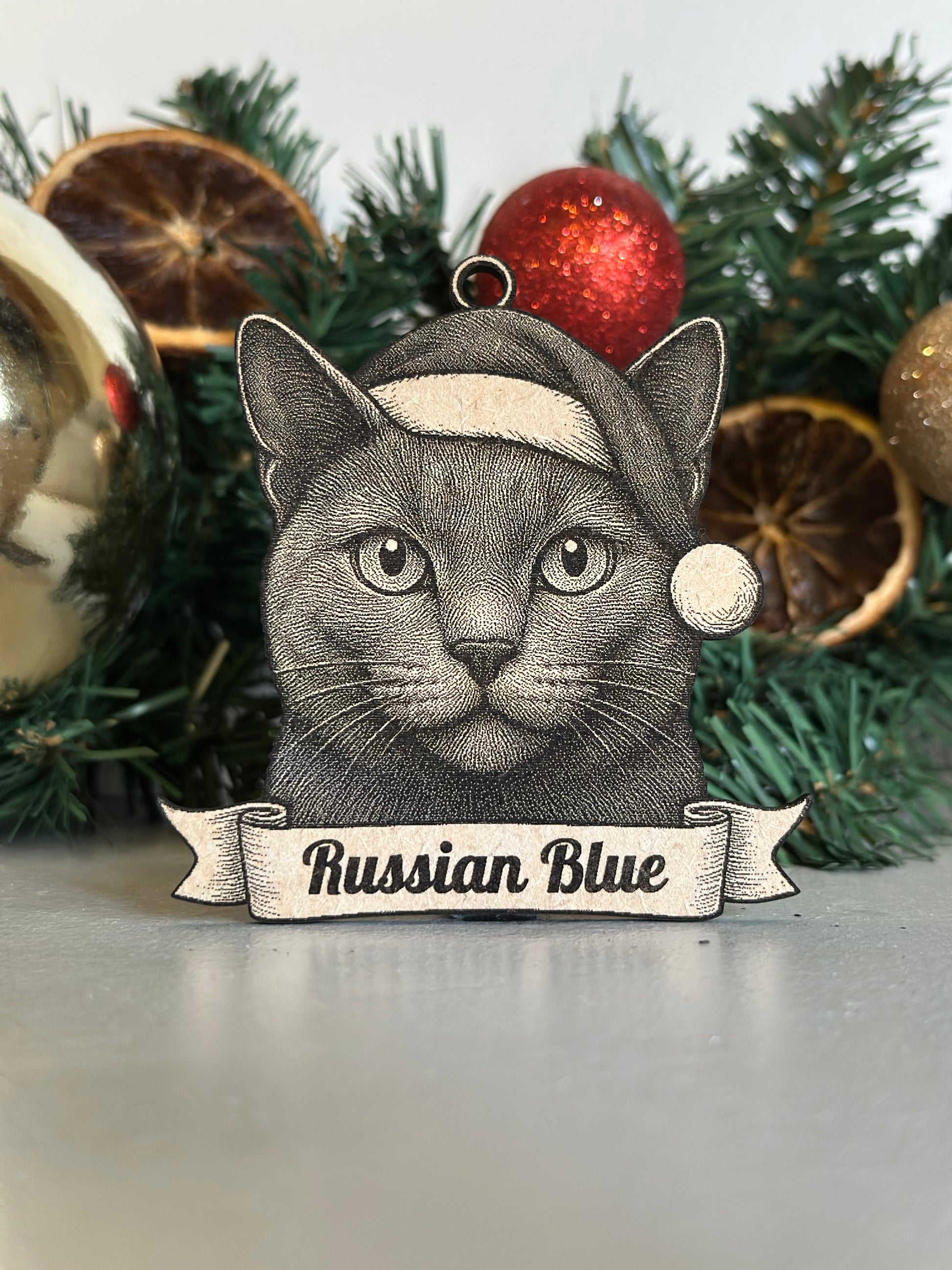 Christmas ornament with a Russian Blue cat design on a decorated tree.