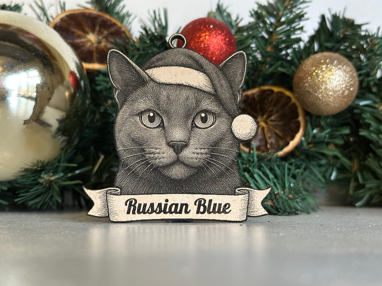 Cat-themed ornament with 'Russian Blue' text on a Christmas tree