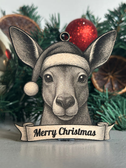 Decorative kangaroo ornament with 'Merry Christmas' tag on a Christmas tree.