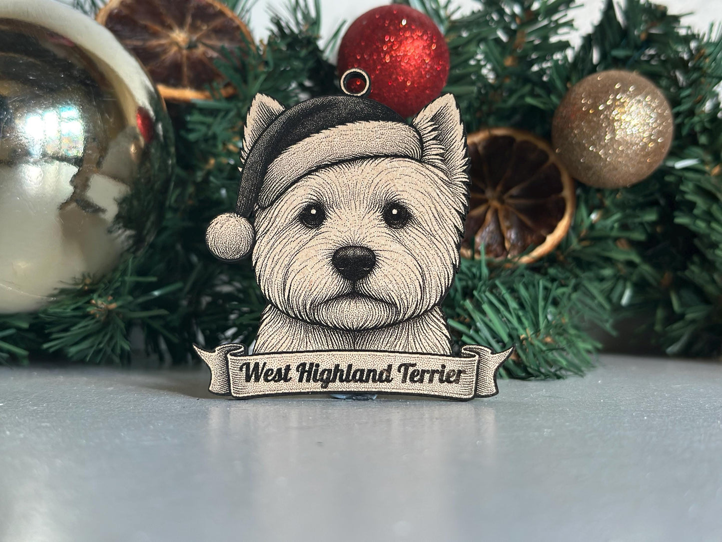 West Highland Terrier ornament with a Santa hat in front of Christmas decorations