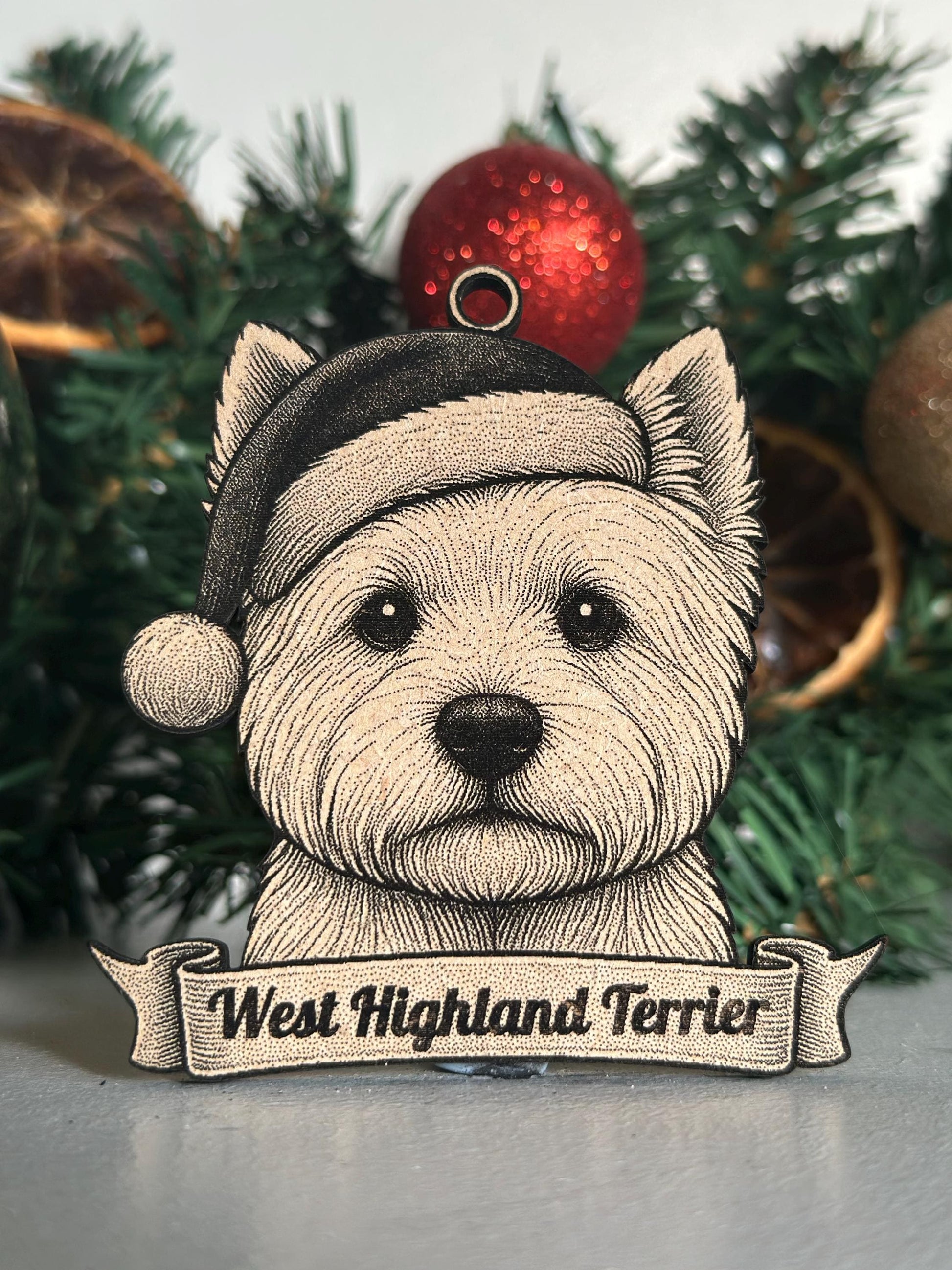 West Highland Terrier ornament with a Santa hat against a Christmas tree background
